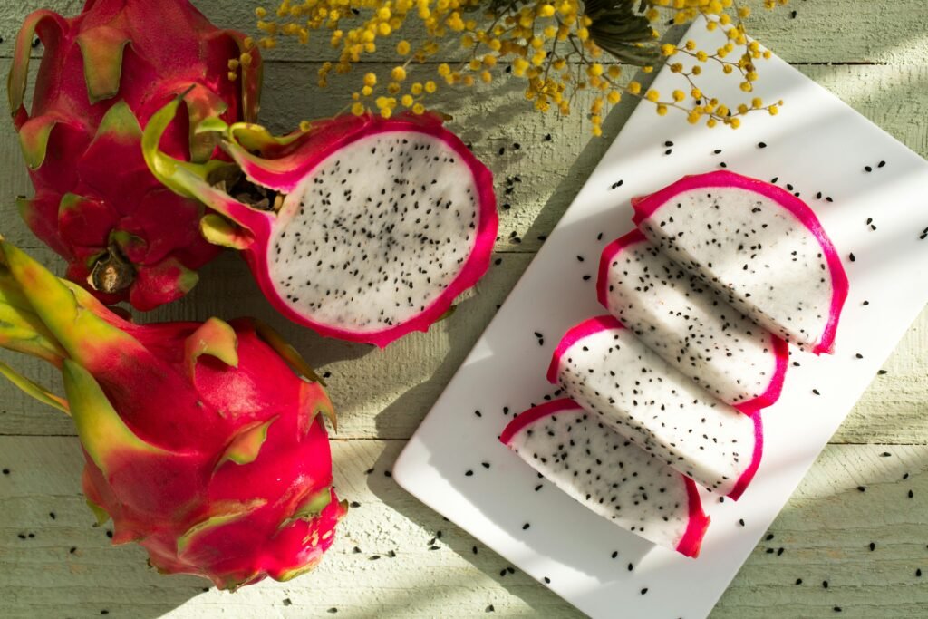 Vibrant dragon fruit slices on wood showcase tropical freshness and healthy eating.